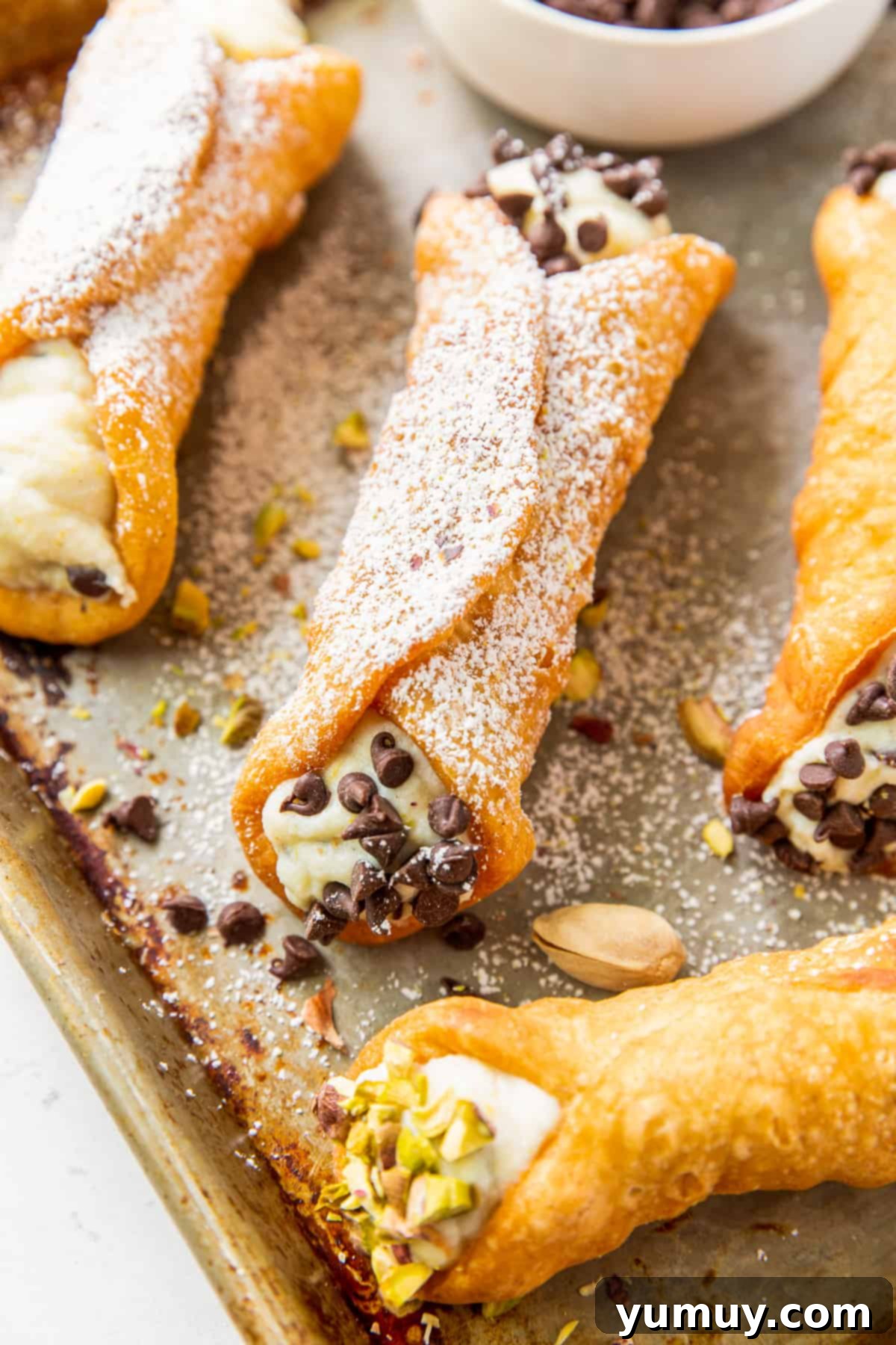 Homemade Cannoli Bliss 3 up close homemade cannolis on baking sheet