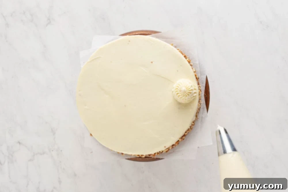 a beautifully frosted orange carrot cake with intricate piping and fresh orange zest.