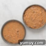 two bowls of brown food, representing the prepared cake batter.