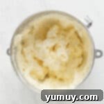 butter in a bowl on a marble countertop, ready for frosting preparation.