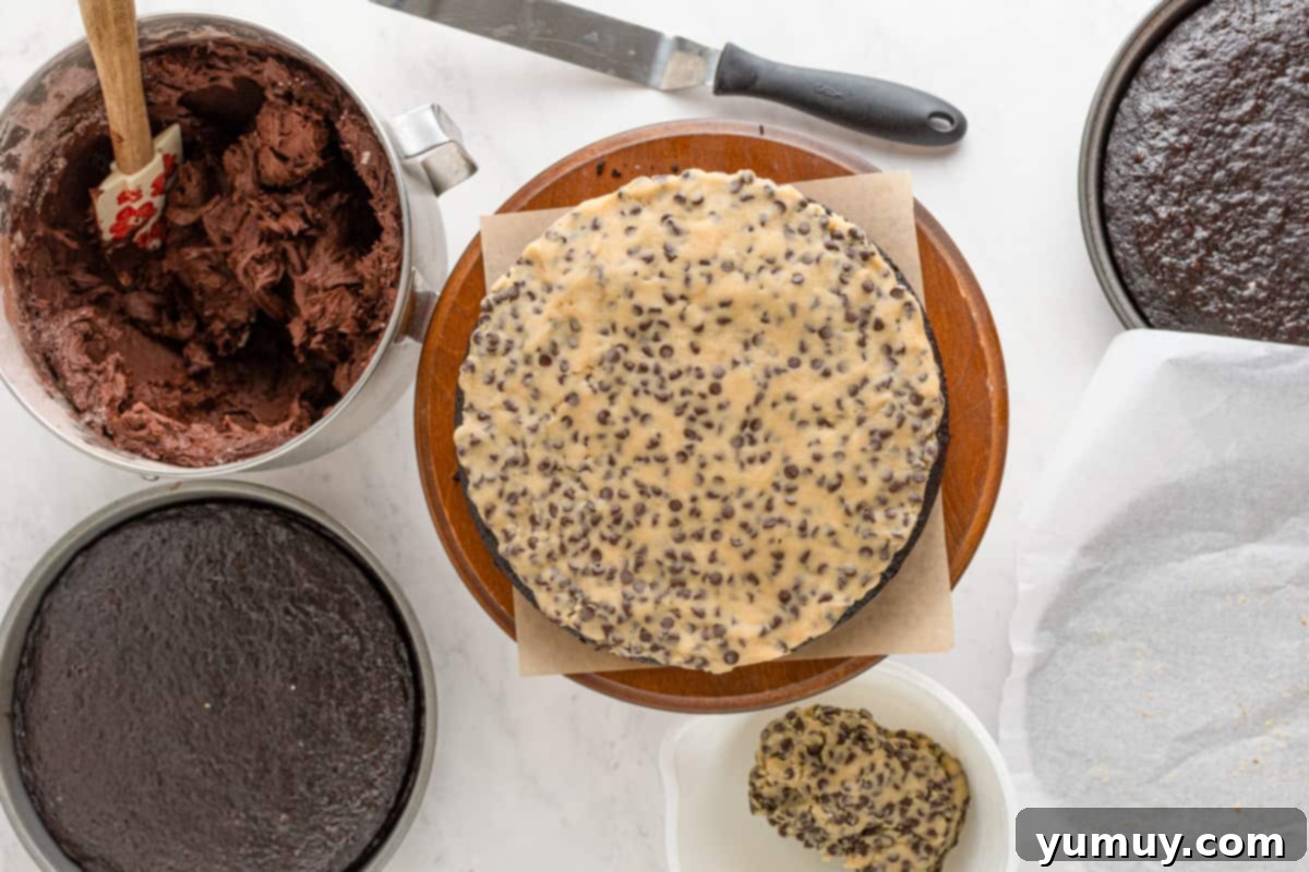 A pristine cookie dough layer gracefully placed on top of a moist chocolate cake layer, showcasing the precise and tempting construction of the cake.