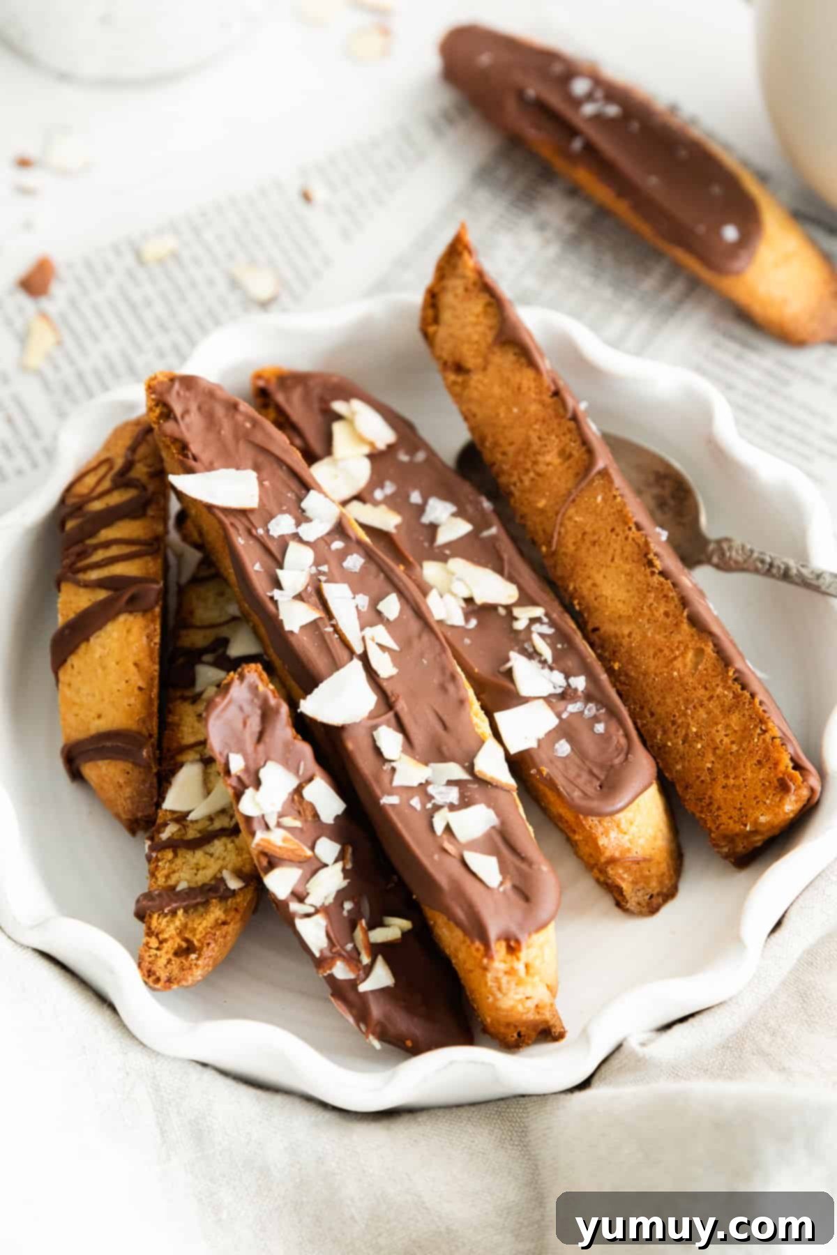 Chocolate Kissed Biscotti 2 chocolate dipped biscotti in white bowl