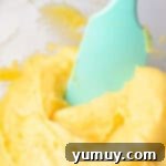 Crispy Chocolate Cruller Twists 9 cruller dough in a glass bowl with a blue spatula