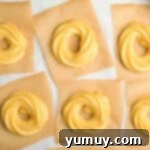 Crispy Chocolate Cruller Twists 10 piped cruller dough in circles on squares of parchment paper