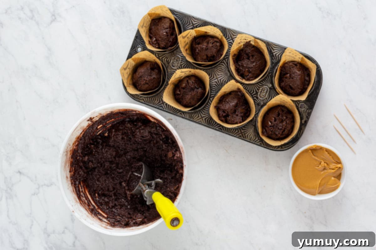 chocolate muffin batter in a muffin tin