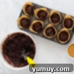 chocolate muffin batter in a muffin tin