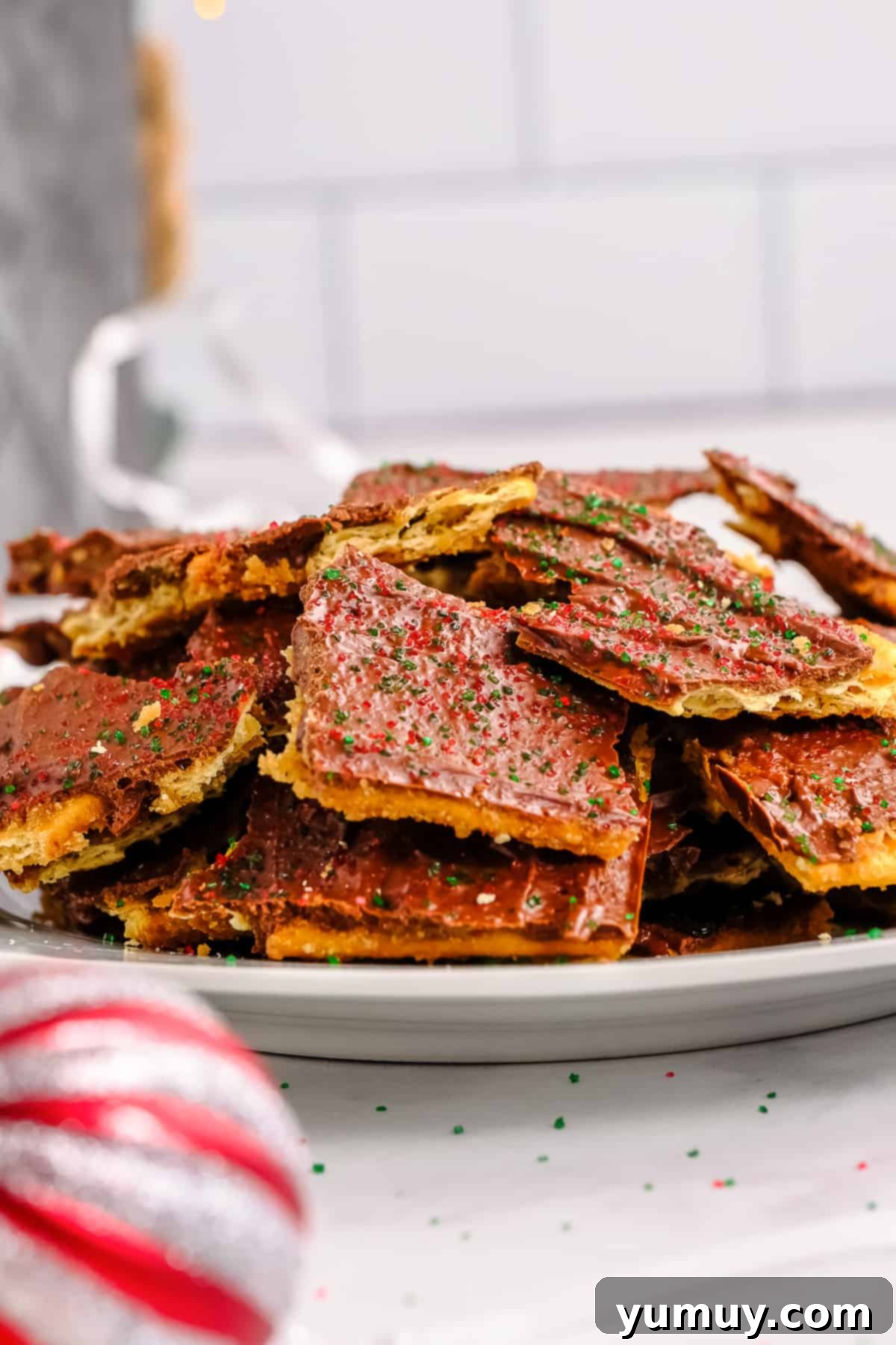 Yuletide Toffee Obsession 2 a pile of christmas crack on a white plate.