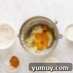 Golden Cinnamon Bundt Cake 12 butter, sugar, and eggs in a stainless steel mixing bowl.