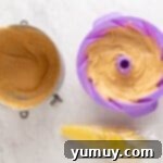 Golden Cinnamon Bundt Cake 14 3/4 churro bundt cake batter in a purple silicone bundt mould.
