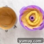 Golden Cinnamon Bundt Cake 15 custard filling piped on top of bundt batter in a purple silicone bundt mould.