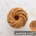 Golden Cinnamon Bundt Cake 18 baked churro bundt cake next to ingredients for churro bunt cake topping.