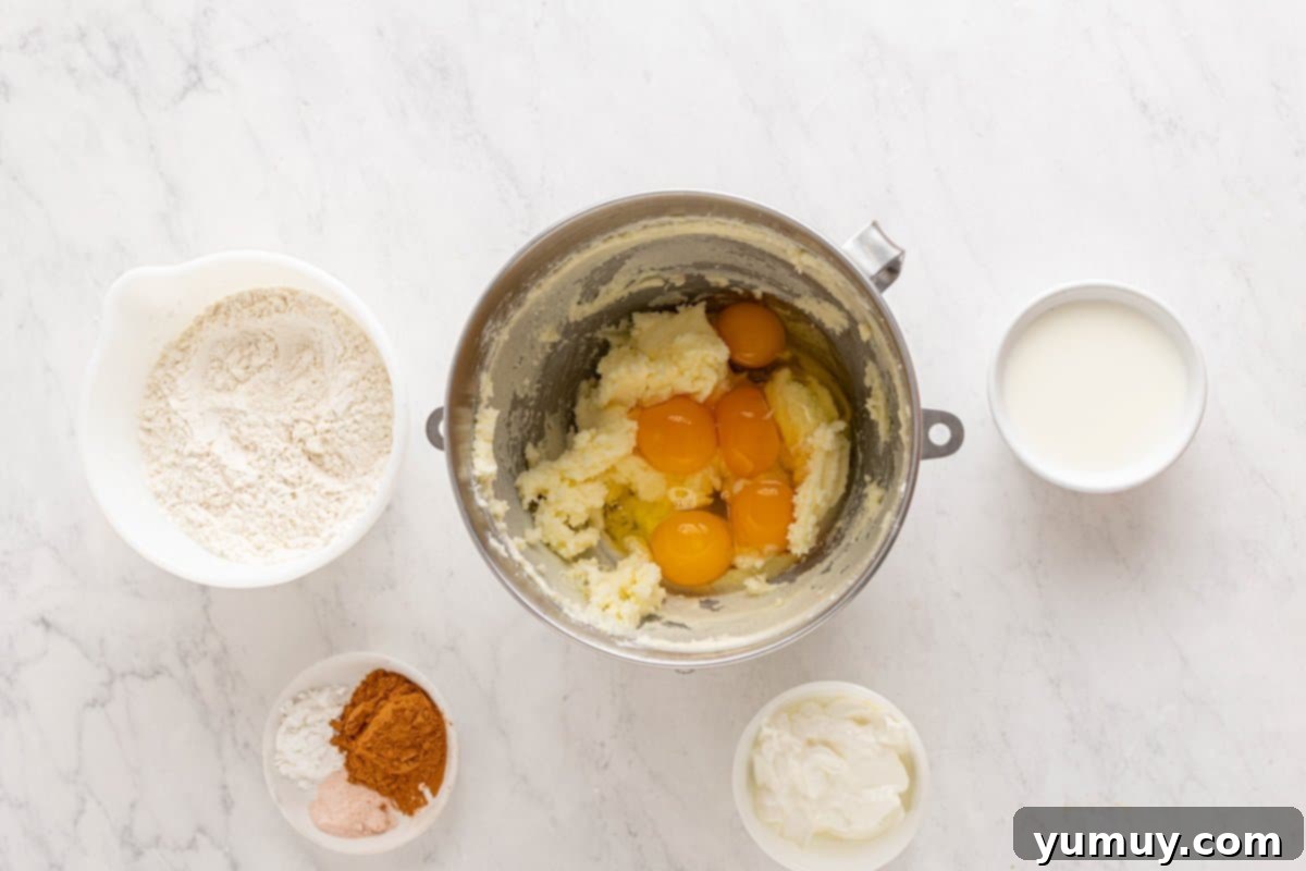 Golden Cinnamon Bundt Cake 27 butter, sugar, and eggs in a stainless steel mixing bowl.