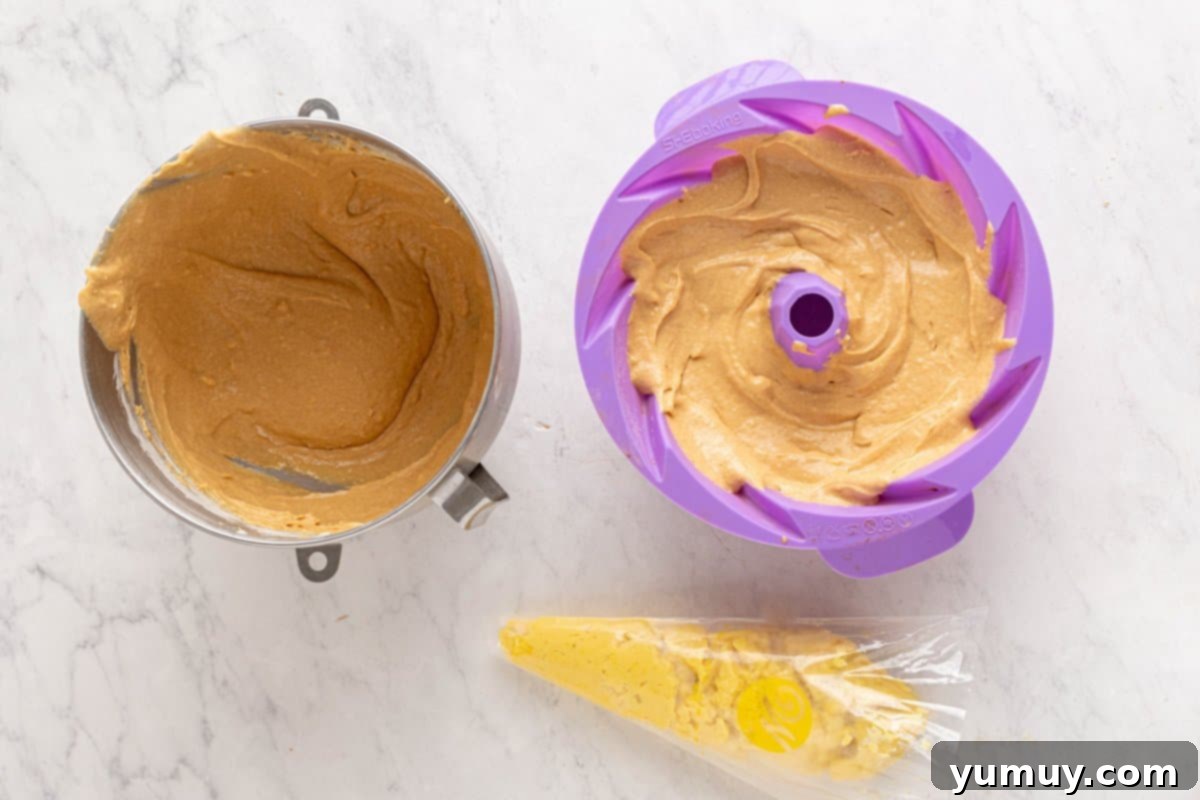 Golden Cinnamon Bundt Cake 29 3/4 churro bundt cake batter in a purple silicone bundt mould.