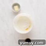 Golden Cinnamon Bundt Cake 7 sugar and cornstarch over whisked eggs in a white bowl.