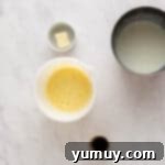 Golden Cinnamon Bundt Cake 8 sugar and milk mixture whisked into egg mixture in a white bowl.