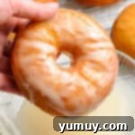 Homemade Krispy Kreme Glazed Donuts 11 dipping donut into glaze