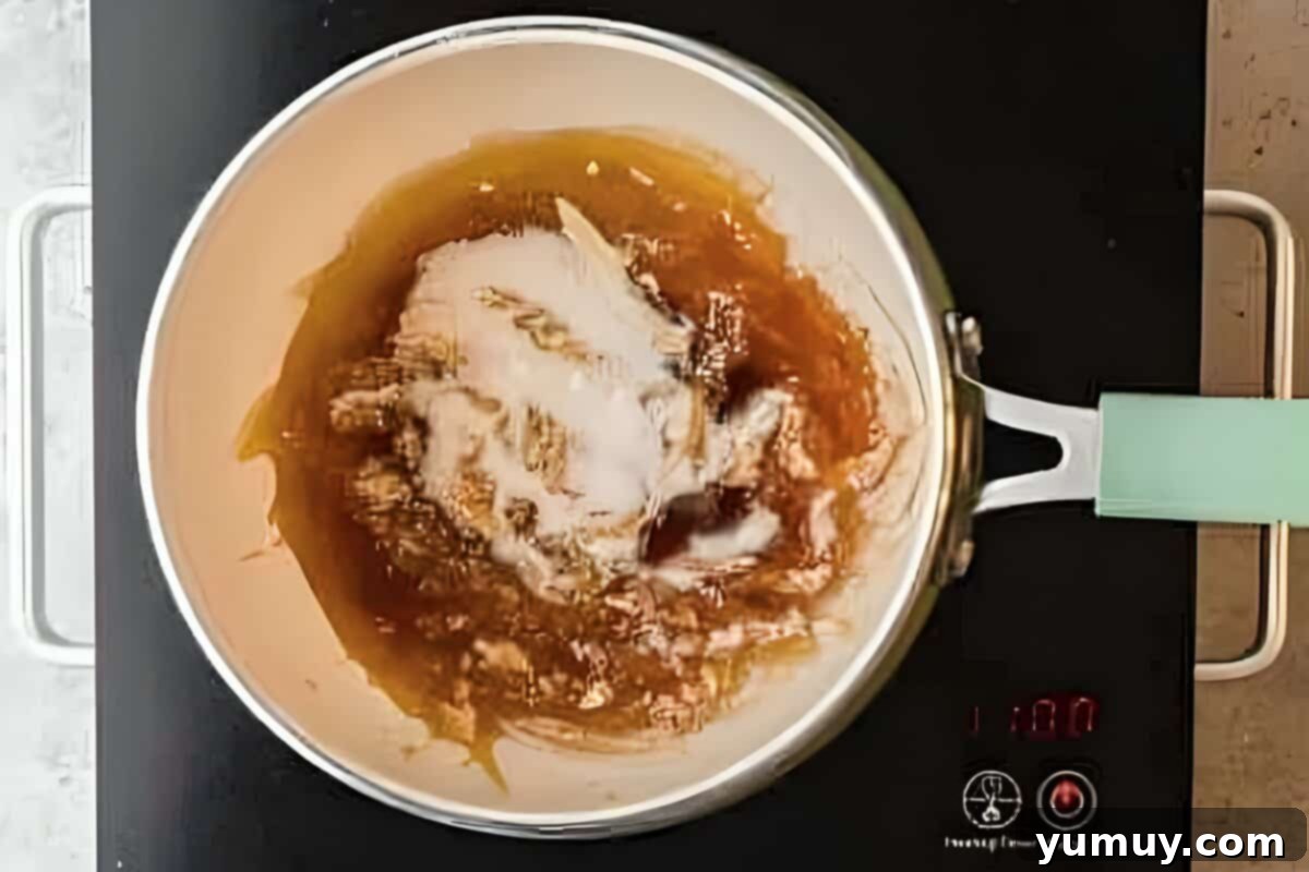 Sugar caramelizing in a pot, transitioning into a beautiful golden-brown syrup.