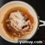 Mixture caramelizing in a pot, turning golden brown.