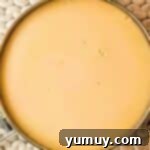 Freshly baked flan still in its round pan, removed from the oven.