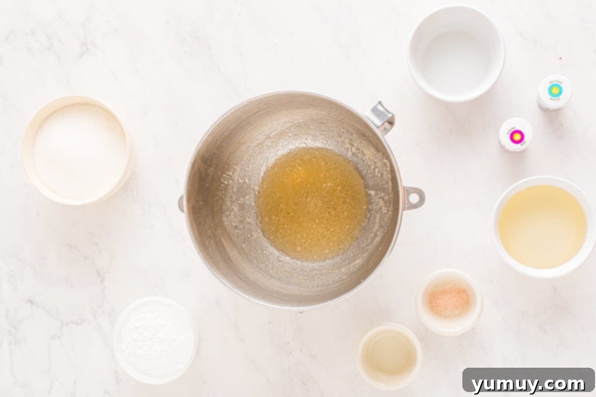 Spun Sugar Pillows 11 Gelatin powder and cold water in a stand mixer bowl, showing the initial blooming stage for marshmallow preparation.
