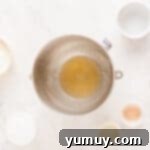 Spun Sugar Pillows 5 The ingredients for a cake are shown on a white table, including gelatin powder and water, ready for blooming.