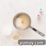 Spun Sugar Pillows 6 Cotton candy marshmallow ingredients, including sugar, corn syrup, and water, simmering in a saucepan on the stovetop.