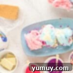 Cloud Nine S'mores 6 cotton candy and sprinkles on top of white chocolate and graham crackers on a blue plate