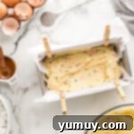 Funfetti pound cake batter smoothed into a loaf pan, ready for baking.