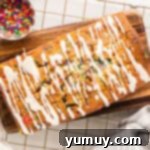 Overhead view of a beautiful funfetti pound cake with a fresh glaze drizzle.