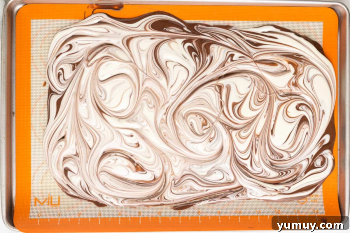 Melted white and milk chocolate swirled together.