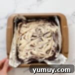 cream cheese swirl brownies in a foil-lined baking pan before baking.