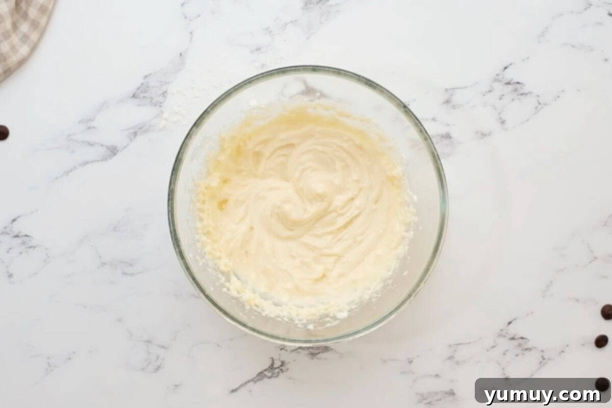 beaten sweetened cream cheese in a bowl.