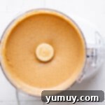 Craft Your Own Peanut Butter 6 Homemade peanut butter in a food processor, showing a smooth, creamy texture.