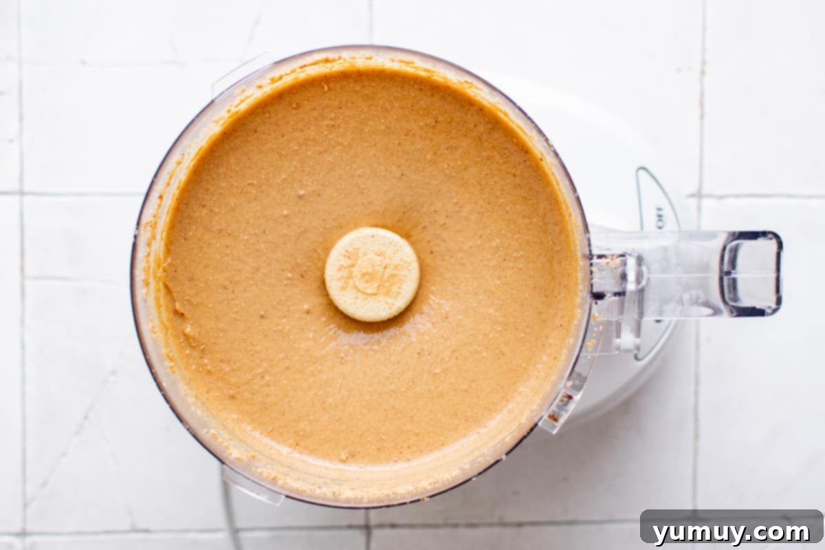 Craft Your Own Peanut Butter 9 Homemade peanut butter in a food processor, now smooth and creamy after adding salt and final blending.