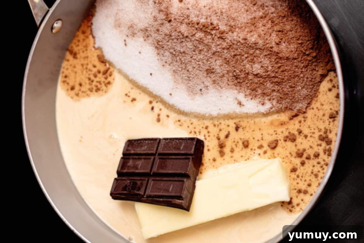 Decadent Chocolate Fudge Sauce 10 Unsalted butter, unsweetened baking chocolate, and evaporated milk are poised in a saucepan, ready to be cooked into a rich hot fudge sauce.