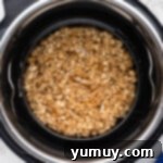 Apple crisp baking dish placed on a trivet inside an Instant Pot with water at the bottom.