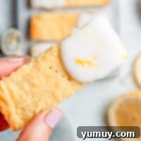 Delightful iced lemon shortbread cookies arranged neatly on a cooling rack.