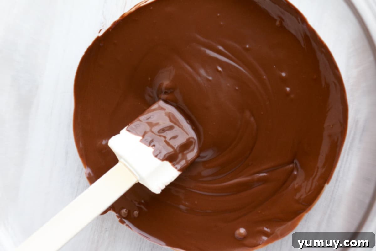 Festive Pretzel Bark 9 Visual guide: Melting chocolate in a bowl, showing the smooth, liquid texture.