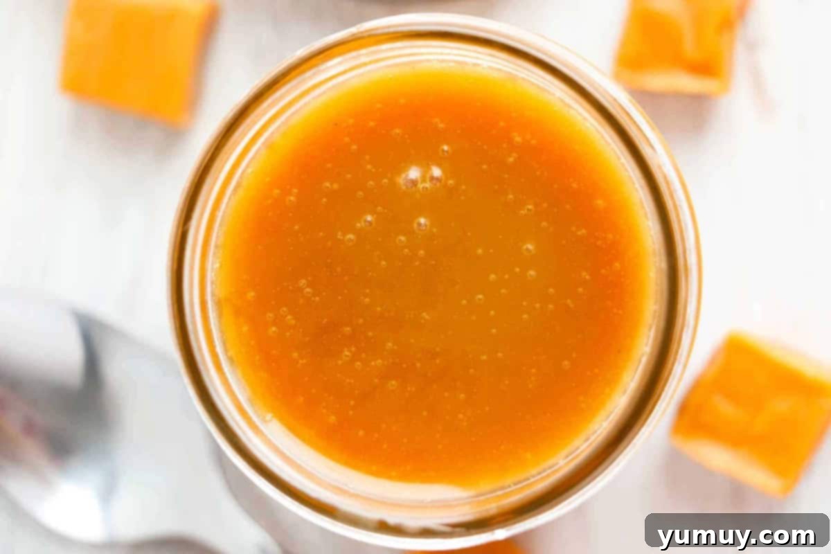 Overhead view of luscious brown sugar caramel sauce in a glass jar, showcasing its inviting texture.