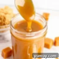 Drizzling brown sugar caramel from a spoon into a mason jar.