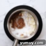 Brown sugar, butter, and cream in a saucepan, ready to be heated.