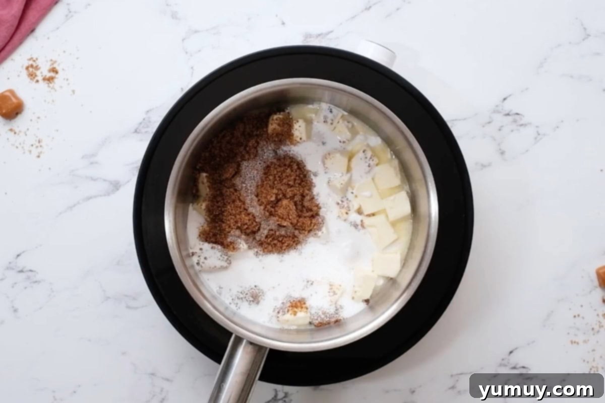 Brown sugar, butter, and cream combined in a saucepan, ready for heating.