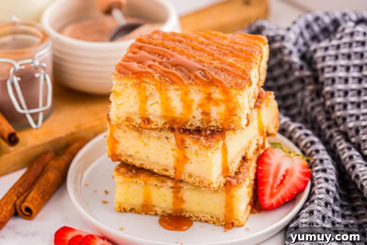 Three decadent churro cheesecake bars, elegantly stacked and drizzled with luscious caramel sauce, presented on a pristine white plate.
