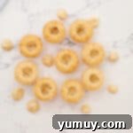 Baked cupcakes with their centers carefully cored out, ready for filling.