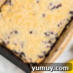 Blueberry Bliss Bars 9 baked blueberry pie bars in a baking pan.