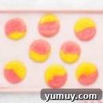 A baking tray filled with perfectly baked strawberry lemonade cookies, cooling down.
