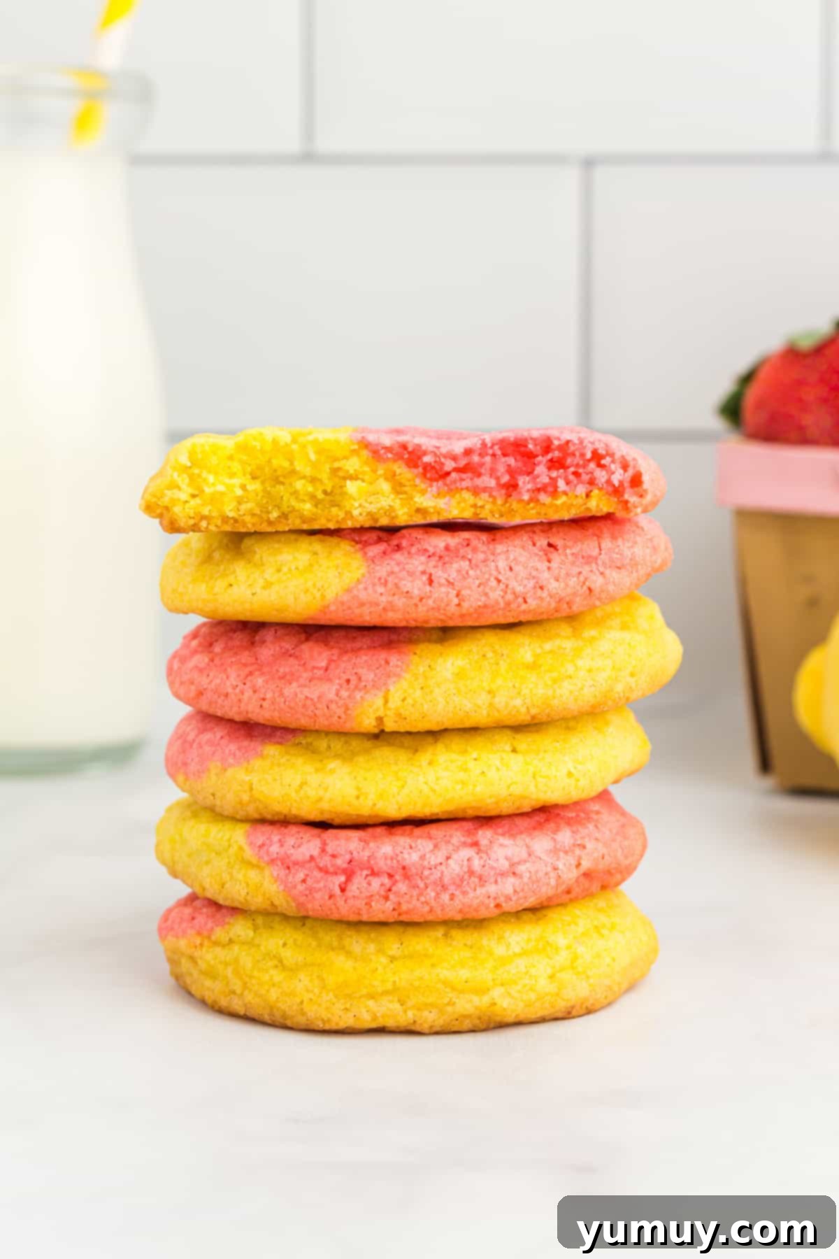 A charming stack of pink and yellow strawberry lemonade cookies, ready to be enjoyed.