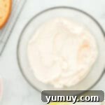 Vibrant Strawberry Lemon Cake 11 white frosting in a glass bowl.