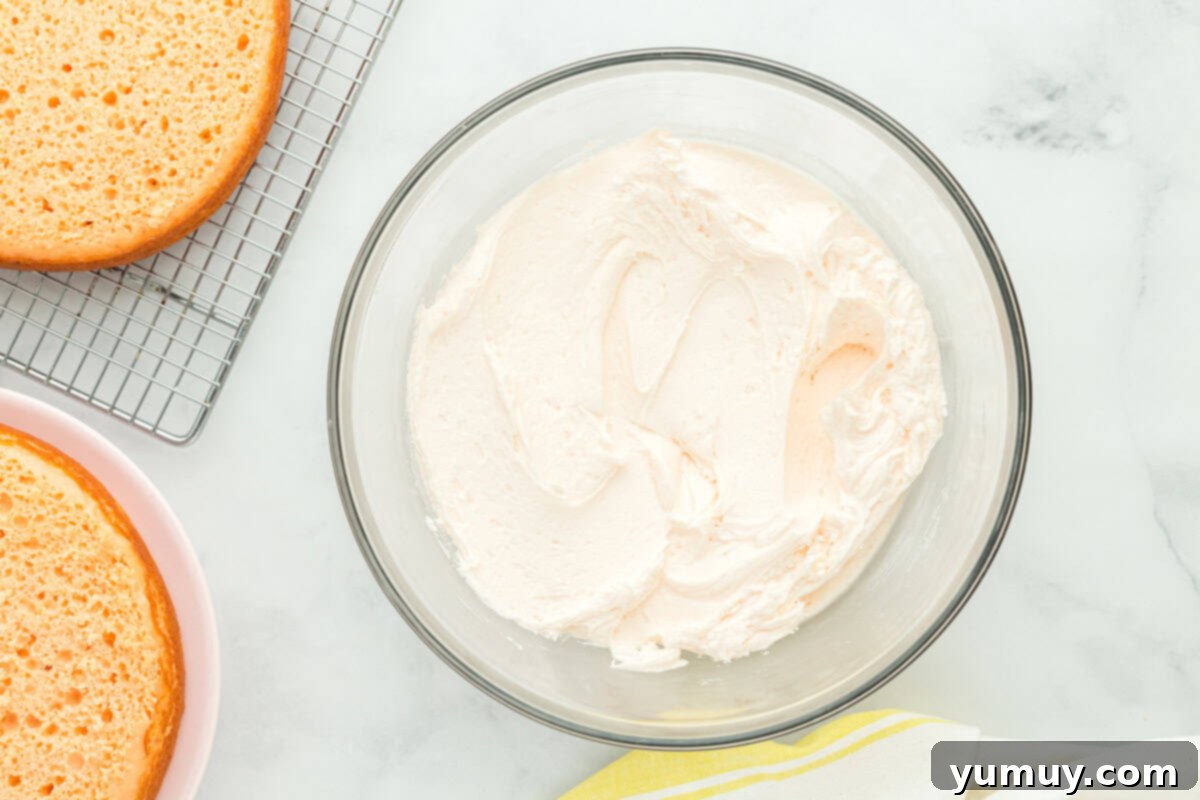 Vibrant Strawberry Lemon Cake 21 white frosting in a glass bowl.