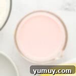 Vibrant Strawberry Lemon Cake 7 pink liquid in a glass bowl.